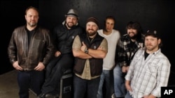 The Zac Brown Band, from left, John Driskell Hopkins, Coy Bowles, Zac Brown, Jimmy De Martini, Clay Cook, and Chris Fryar are shown in Nashville, Tennessee, Dec. 29, 2010.