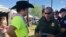 In this April 6, 2017 photo, a U.S. Border Patrol agent gives information about working for the agency to 24-year-old Ric Kindle, of the Phoenix area, at the Country Thunder Music Festival in Florence, Ariz. 