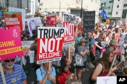 FILE - Protesters rally against U.S. President Donald Trump's visit to London, Britain, July 13, 2018.
