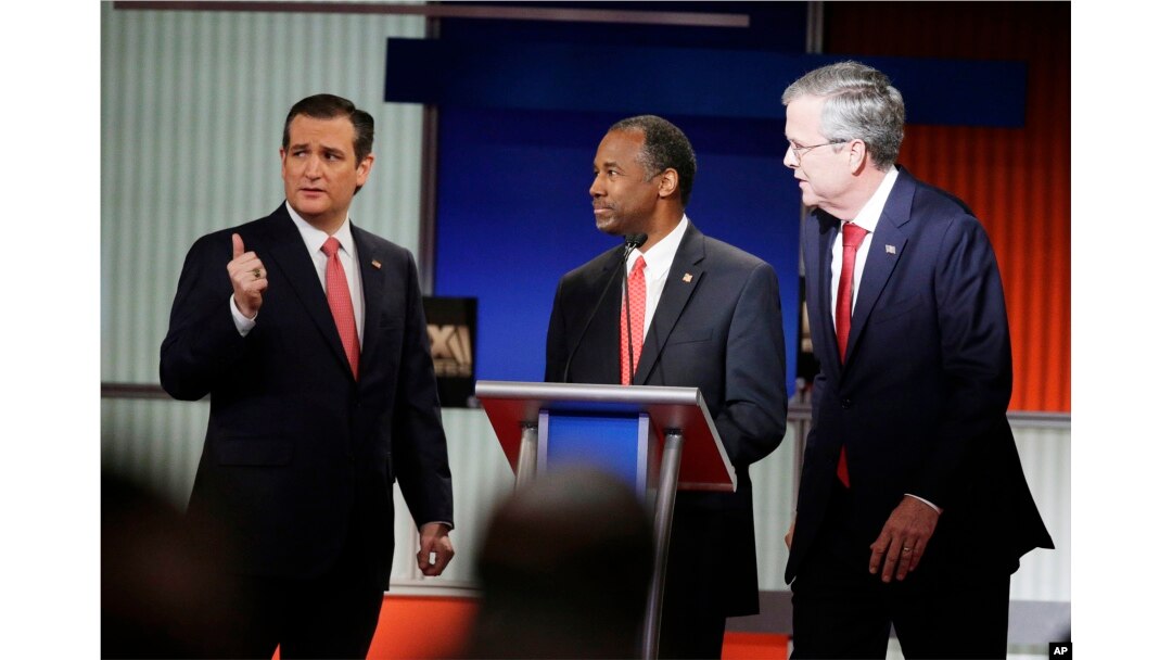 Republican presidential candidates Sen. Ted Cruz, left, retired neurosurgeon Ben Carson and former Florida Gov. Jeb Bush chat during the Fox Business Network Republican presidential debate at the North Charleston Coliseum in North Charleston, S.C., Jan. 14, 2016.