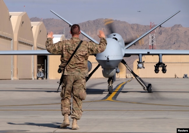 FILE - A U.S. airman guides a U.S. Air Force MQ-9 Reaper drone as it taxis to the runway at Kandahar Airfield, Afghanistan, March 9, 2016. Afghan security forces have been provided with surveillance drones for use in restive regions.