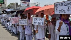Schoolgirls holding placards participate in a protest rally against the rape of two teenage girls in Chatra and Pakur districts of eastern state of Jharkhand, in Ranchi, India, May 8, 2018.