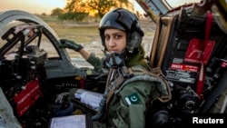 Ayesha Farooq, 26, Pakistan's only female war-ready fighter pilot, poses for photograph as she sits in a cockpit of a Chinese-made F-7PG fighter jet at Mushaf base in Sargodha, Pakistan, June 6, 2013. 