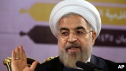 Iranian President Hassan Rouhani gestures as he speaks during a press conference in Tehran, Iran, Saturday, June 14, 2014. 