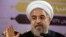 Iranian President Hassan Rouhani gestures as he speaks during a press conference in Tehran, June 14, 2014. 