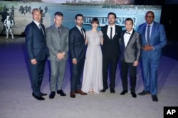 Actors from left, Mads Mikkelsen, Ben Mendelsohn, Riz Ahmed, Felicity Jones, Diego Luna, Donnie Yen and Forest Whitaker pose for photographers upon arrival at the Rogue One: A Star Wars premiere in London, Dec. 13, 2016.