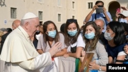 Pope Francis greets faithful as he attends the weekly general audience at the Vatican, Sept. 16, 2020. 