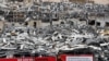 A worker sets banners at the port warehouses that were destroyed by Aug. 4 explosion that hit the seaport of Beirut, Lebanon, Aug. 19, 2020.