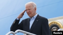 President Joe Biden salutes while boarding Air Force One as he departs on travel to attend the G-7 Summit in England, the first foreign trip of his presidency, from Joint Base Andrews, Maryland, June 9, 2021. 