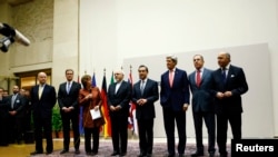 EU foreign policy chief Catherine Ashton, third from left, delivers statement during ceremony marking deal between Iran, six world powers, United Nations, Geneva, Nov. 23, 2013.