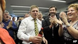 Robert Fico, center, leader of the Smer-Social Democrats celebrates with party members on Sunday, March 11, 2012, in Bratislava, Slovakia.