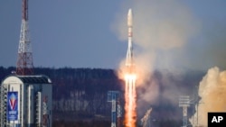 FILE - In this photo released by Roscosmos space corporation on Feb. 29, 2024, a rocket carrying an Iranian satellite blasts off near Tsiolkovsky, Russia. Iranian media reported on Oct. 12, 2024, that it has sent two more satellites to Russia to be put into orbit.