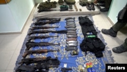 Weapons and equipment which Israel's army says it found at the Shifa Hospital complex in the Gaza Strip, as seen in a handout picture released by the Israel Defense Forces on Nov. 15, 2023.