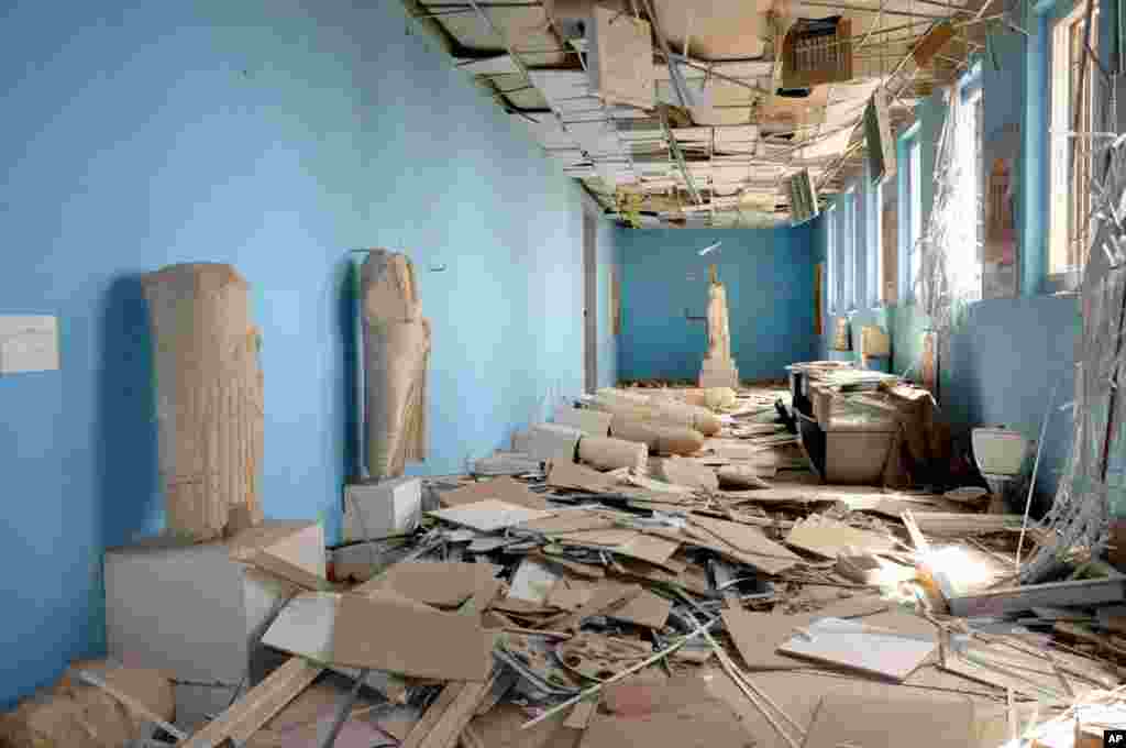 This photo released on Sunday March 27, 2016, by the Syrian official news agency SANA, shows destroyed statues at the damaged Palmyra Museum, in Palmyra city, central Syria. 