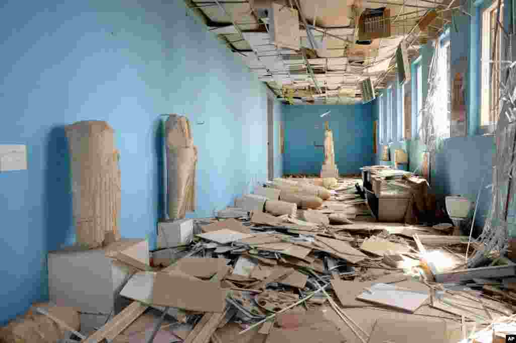 This photo released on Sunday March 27, 2016, by the Syrian official news agency SANA, shows destroyed statues at the damaged Palmyra Museum, in Palmyra city, central Syria.
