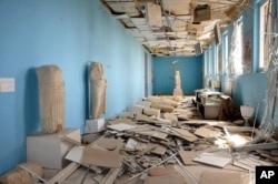 This photo released on Sunday March 27, 2016, by the Syrian official news agency SANA, shows destroyed statues at the damaged Palmyra Museum, in Palmyra city, central Syria.