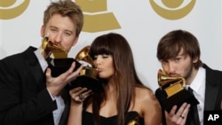 Lady Antebellum, from left, Charles Kelley, Hillary Scott and Dave Haywood pose backstage with the award for best record of the year at the 53rd annual Grammy Awards on Sunday, Feb. 13, 2011, in Los Angeles.