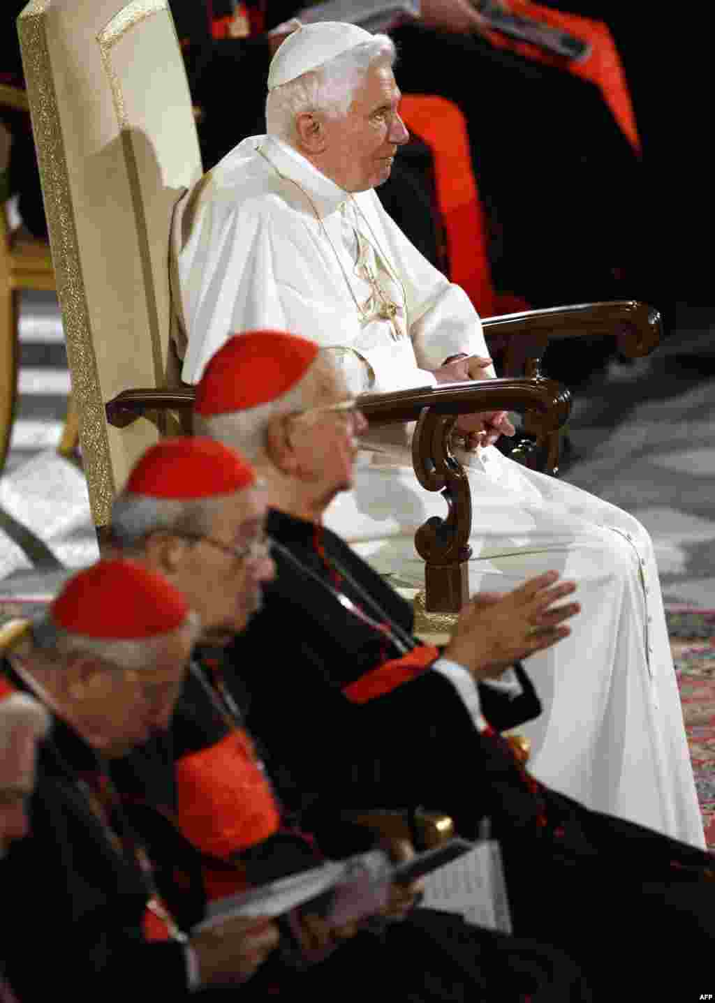 Pope Benedict XVI sits in the Paul VI hall at the Vatican as he attends the concert "Messa da Requiem" of Italian composer Giuseppe Verdi presented by German director Enoch zu Guttemberg, Saturday, Oct. 16, 2010. (AP Photo/Pier Paolo Cito)