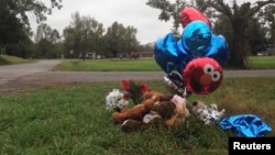 A makeshift memorial of balloons and stuffed animals lies near the site in Marksville, Louisiana, where a 6-year-old boy was fatally shot by police during a car chase, November 7, 2015.
