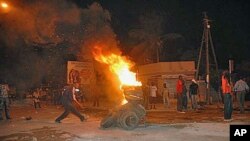 Protesters burn tires in a street after Senegal's highest court ruled that the country's increasingly frail, 85-year-old President Abdoulaye Wade could run for a third term in next month's presidential election, in Dakar, Senegal, January 27, 2012.