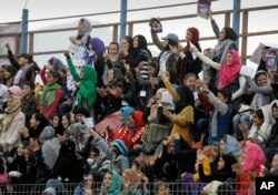 Afghan women cheer during the final match of the Afghan football premier league in Kabul, Afghanistan, Oct. 18, 2012.