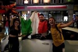 Italian fans celebrate in central London, in the early hours of July 12, 2021, after Italy won the Euro 2020 soccer championship final match between England and Italy played at Wembley Stadium.