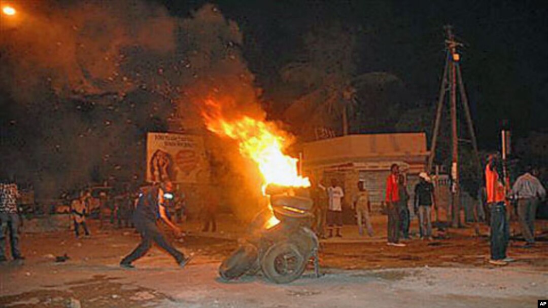 Protesters burn tires in a street after Senegal's highest court ruled that the country's increasingly frail, 85-year-old President Abdoulaye Wade could run for a third term in next month's presidential election, in Dakar, Senegal, January 27, 2012.