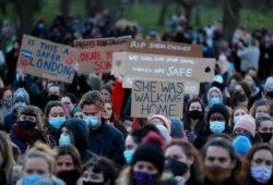 People gather in Clapham Common in memory of Sarah Everard, after an official vigil for the slain kidnapping victim was canceled, in London, March 13, 2021.