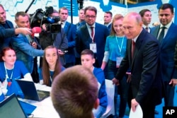 Russian President Vladimir Putin meets with students in Yaroslavl, Russia, Sept. 1, 2017. Putin said the development of artificial intelligence raises "colossal opportunities and threats that are difficult to predict now."