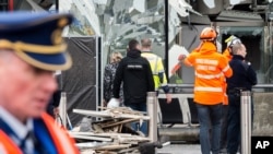 Police and other emergency workers stand in front of the damaged Zaventem Airport terminal in Brussels on March 23, 2016. 