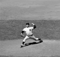 FILE - Whitey Ford of the New York Yankees as he pitched a five-hitter against the Chicago White Sox for his 13th victory of the year, July 4, 1963, in the first game of a doubleheader, in New York.