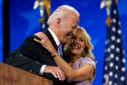 FILE - Democratic presidential candidate Joe Biden hugs his wife, Jill Biden, after his speech during the fourth day of the Democratic National Convention, Aug. 20, 2020, at the Chase Center in Wilmington, Del.