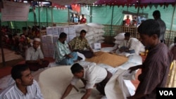 FILE - Muslims distribute food aid at Thet Kae Pyin Camp, outside Sittwe, Rakhine State, Myanmar, November, 2012. (D. Schearf/VOA)