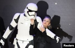 FILE - Carrie Fisher poses for cameras as she arrives at the European Premiere of "Star Wars, The Force Awakens" in Leicester Square, London, Dec. 16, 2015.