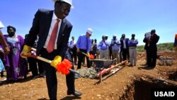 The governor of Baringo County, Benjamin Cheboi (left), was joined by USAID associate administrator Mark Feierstein (blue shirt) in breaking ground for a new power plant in Kenya. (Courtesy USAID) 