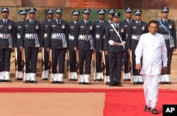 Sri Lanka’s President Maithripala Sirisena inspects a guard of honor during a ceremonial reception at the Indian Presidential Palace in New Delhi, India, Feb. 16, 2015.