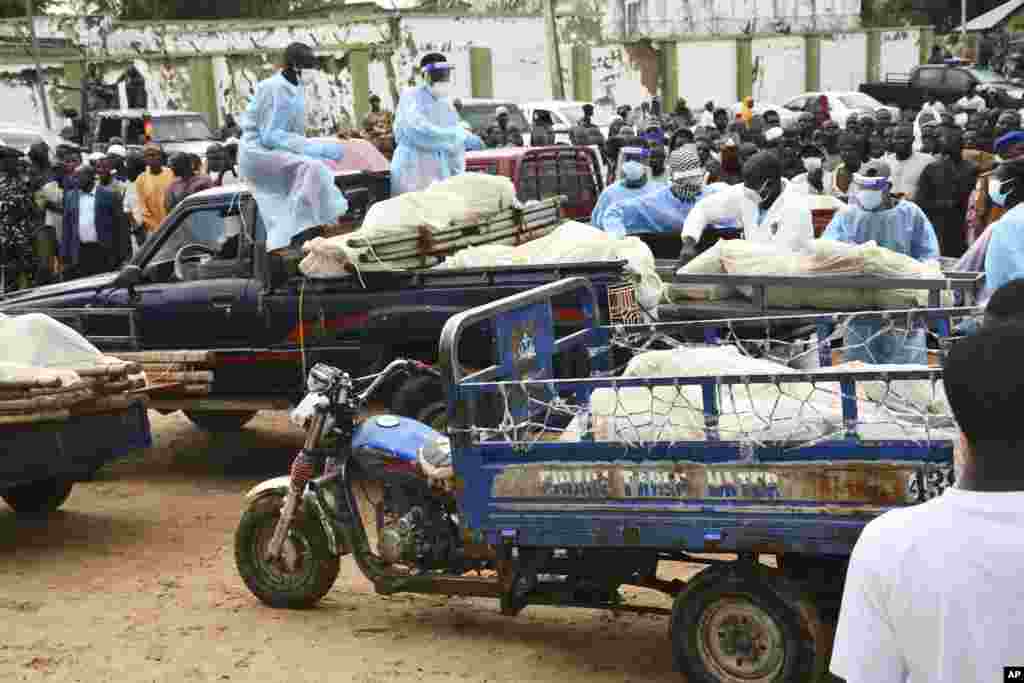 Bodies of people killed by suspected Boko Haram Islamist extremists are transported for burial, in Tarmuwa, northeast Nigeria, Sept. 3, 2024. (AP Photo/Michael Abu)