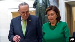 Senate Minority Leader Sen. Chuck Schumer of N.Y., and House Speaker Nancy Pelosi of Calif., walk together as they head to a lunch with Irish Prime Minister Leo Varadkar on Capitol Hill in Washington, March 12, 2020. 