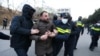 Police officers escort a protester away during an anti-government rally demanding new parliamentary elections in Tbilisi, Georgia Feb. 2, 2025.