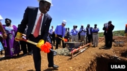 The governor of Baringo County, Benjamin Cheboi (left), was joined by USAID associate administrator Mark Feierstein (blue shirt) in breaking ground for a new power plant in Kenya. (Courtesy USAID) 