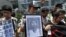 Protesters mourn the death of Chinese labor activist Li Wangyang, seen in picture at center, during a protest outside the Chinese central government's liaison office, in Hong Kong June 7, 2012. 