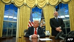 US President Donald Trump speaks to the press after signing an executive order, alongside US Secretary of Commerce nominee Howard Lutnick (R), in the Oval Office of the White House in Washington, DC, on February 10, 2025. (Photo by ANDREW CABALLERO-REYN