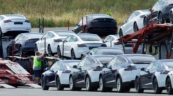 FILE - Tesla cars are loaded onto carriers at the Tesla electric car plant in Fremont, California, May 13, 2020.