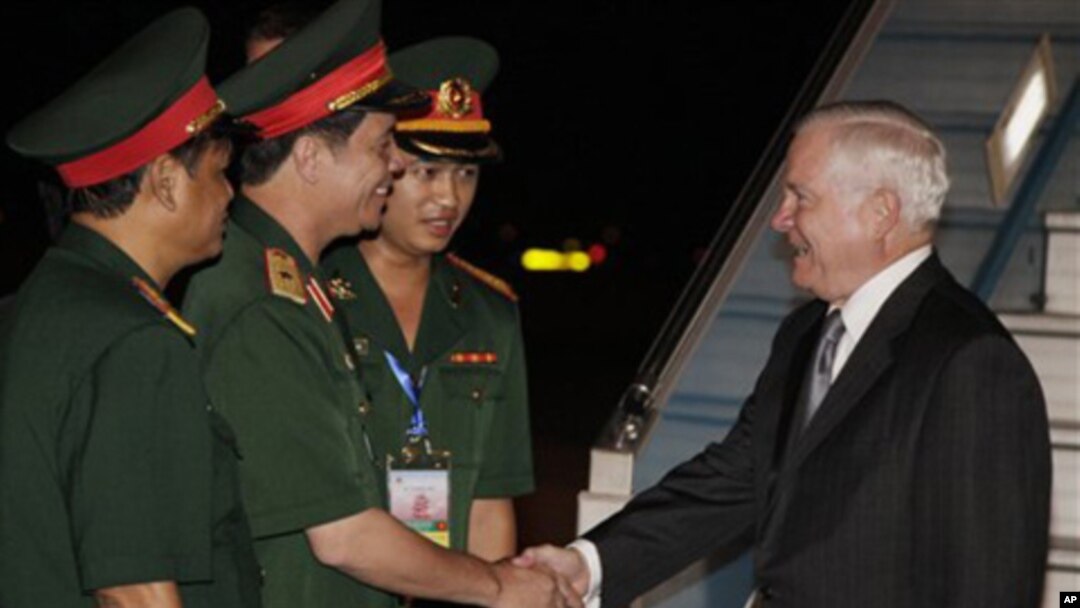 Defense Secretary Robert Gates, right, is greeted by, from left, Sr. Col. Nguyen Hong Quang, Maj. Gen. Nguyen Huu Manh, and Second Lt. Nguyen Thang Anh as he deplanes a U.S. Military Aircraft as he arrives at the Noi Bai International Airport in Hanoi, Vi