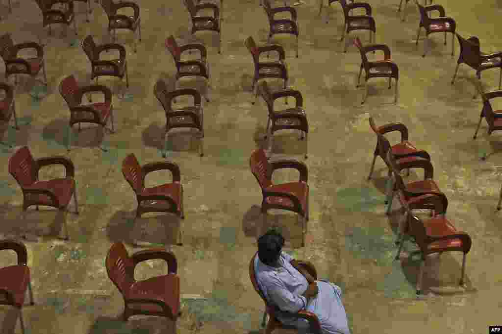 A man waits to get inoculated with the COVID-19 vaccine at a vaccination center in Karachi, Pakistan.