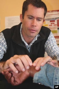 The hospital’s chief physician, Ben Gaunt, carefully examines a patient