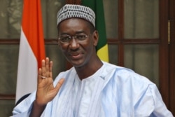 FILE - In this file photo taken on Jan. 16, 2009, Malian offical Moctar Ouane waves prior a meeting in New Delhi.