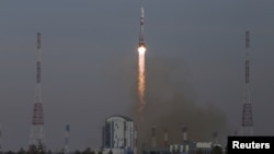 A Soyuz-2.1b rocket booster with a Fregat upper stage and satellites of British firm OneWeb blasts off from a launchpad at the Vostochny Cosmodrome in Amur Region, Russia, March 25, 2021. 