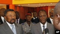 Ivory Coast's internationally-recognized President, Alassane Ouattara, right, addresses journalists following a meeting with African Union commission chairman Jean Ping, left, at the Golf Hotel in Abidjan, Ivory Coast, March 5, 2011