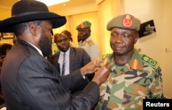 South Sudan's President Salva Kiir decorates newly appointed army chief General James Ajongo during his swearing-in ceremony at the Presidential Palace in Juba, South Sudan, May 10, 2017.